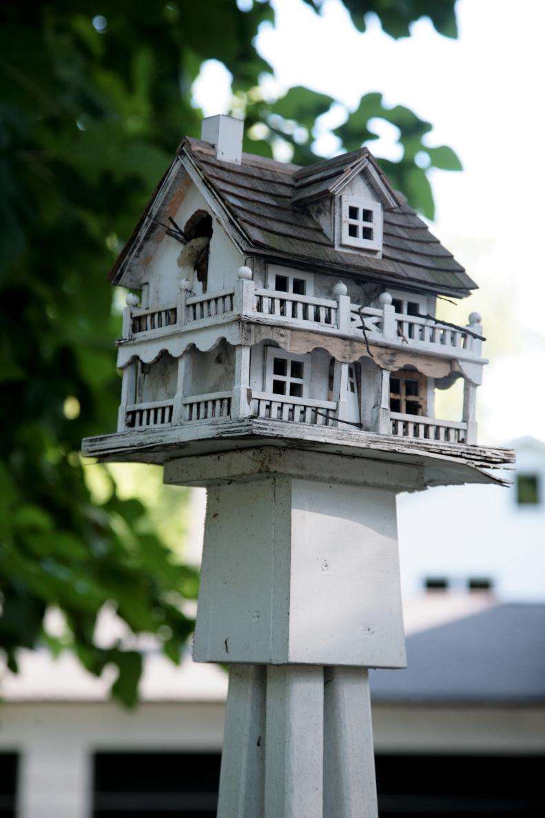 The garden’s five birdhouses also have cottage and English-style looks. This birdhouse was blown down by the wind, but it still serves as a feeder. If you look close, you’ll see where a woodpecker left his mark trying to make the hole big enough to enter.