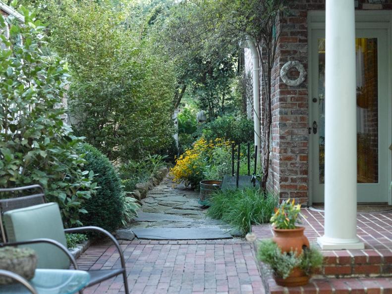 A covered brick porch was added in 2012 to the home, creating more spaces for John and Mary Huntz to enjoy their yard. Rudbeckia matches the blooms on the other side of the garden. She’s also planted camellias, Lady Banks roses, hostas and bronze fennel.