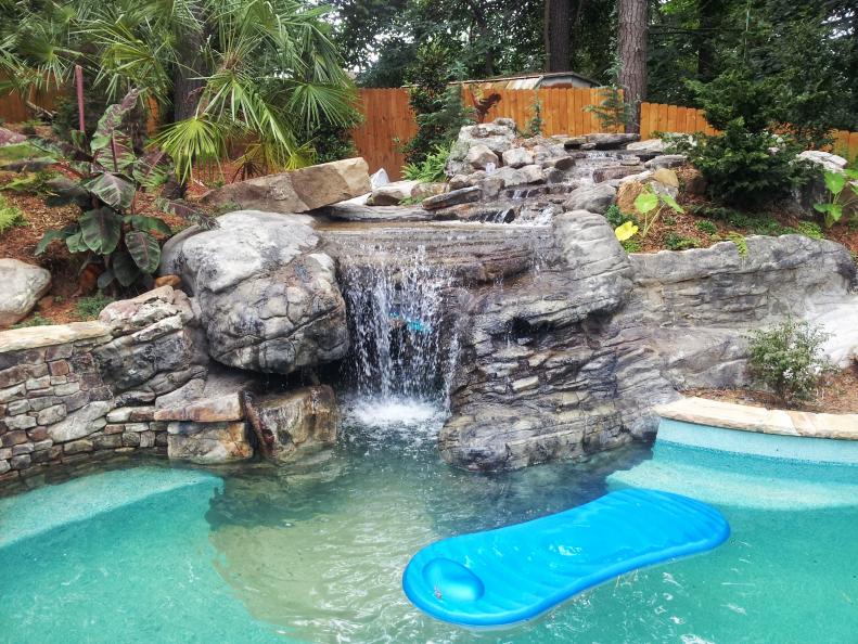 Designers Brad Renken and Chris Carter of Hearthstone Environments take you on a tour of a backyard swimming pool project that evolved into something much more creative and whimsical with unexpected amenities like waterfalls and a private grotto with dinosaur wall art.