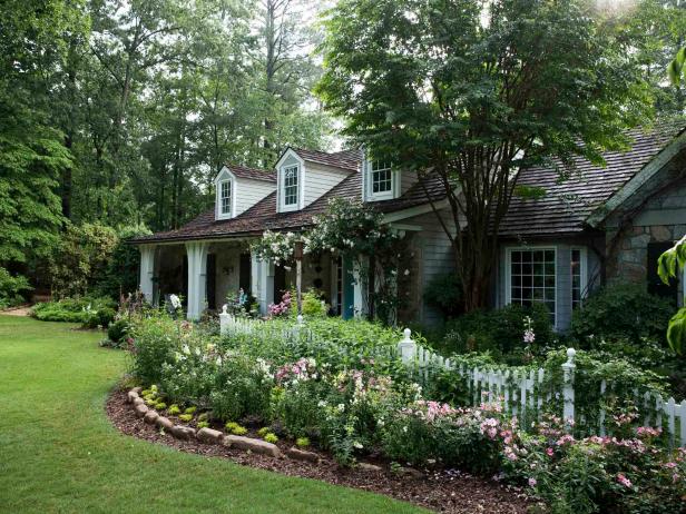 The entry garden at Carole and Jim McWilliams' suburban home is a picket fence-enclosed room spilling with roses, perennials, annuals and shrubs, making for an inviting entrance.