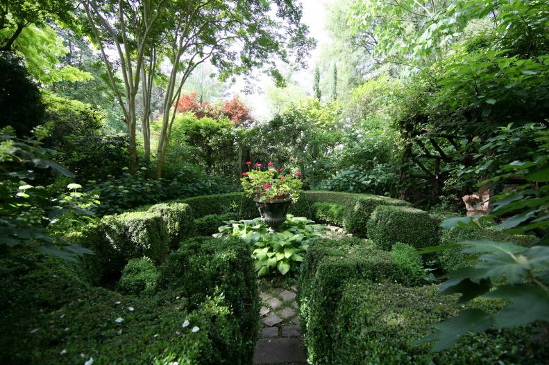 The cottage garden has a sense of formality and reflects its Italian Renaissance roots with the structure of the clipped boxwood and patterns in the stonework. “Since we cannot shape our own destiny, we can shape plants,” Ryan Gainey says.