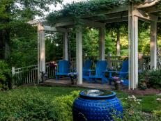 Blue Fountain and Adirondack Chairs Underneath Pergola