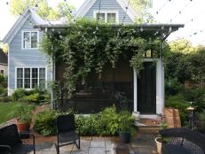 One of&nbsp;Susan Hable's favorite parts of her garden is variegated porcelain vine covering the screened porch. Globe string lights connect the screened porch to a guest cottage.