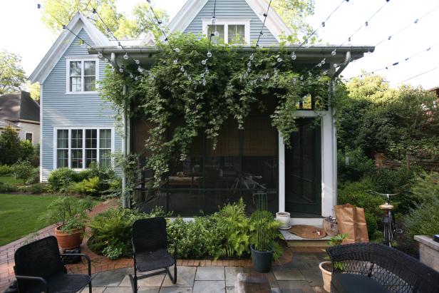 One of&nbsp;Susan Hable's favorite parts of her garden is variegated porcelain vine covering the screened porch. Globe string lights connect the screened porch to a guest cottage.
