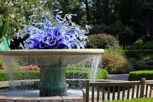 You may not be able to get your hands on a Dale Chihuly work, but any  kind of water feature instantly creates a focal point in the yard. This  focal point in the Atlanta Botanical Garden features Chihuly's Paterre  Fountain Installation, a sculpture of blue and white shapes that emulate  water, ice and sky.