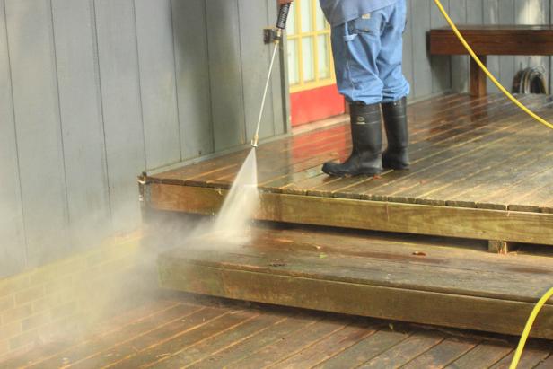 A pressure washer is a powerful tool for cleaning a deck. Take care to  select a nozzle appropriate for the job. Spray nozzles are categorized  by the angle of the spray. A zero degree “red tip” provides the most  powerful stream, but can damage the soft wood. Consider a nozzle with a  spray angle of 25 or even 40 degrees to clean your deck without scarring  the surface.