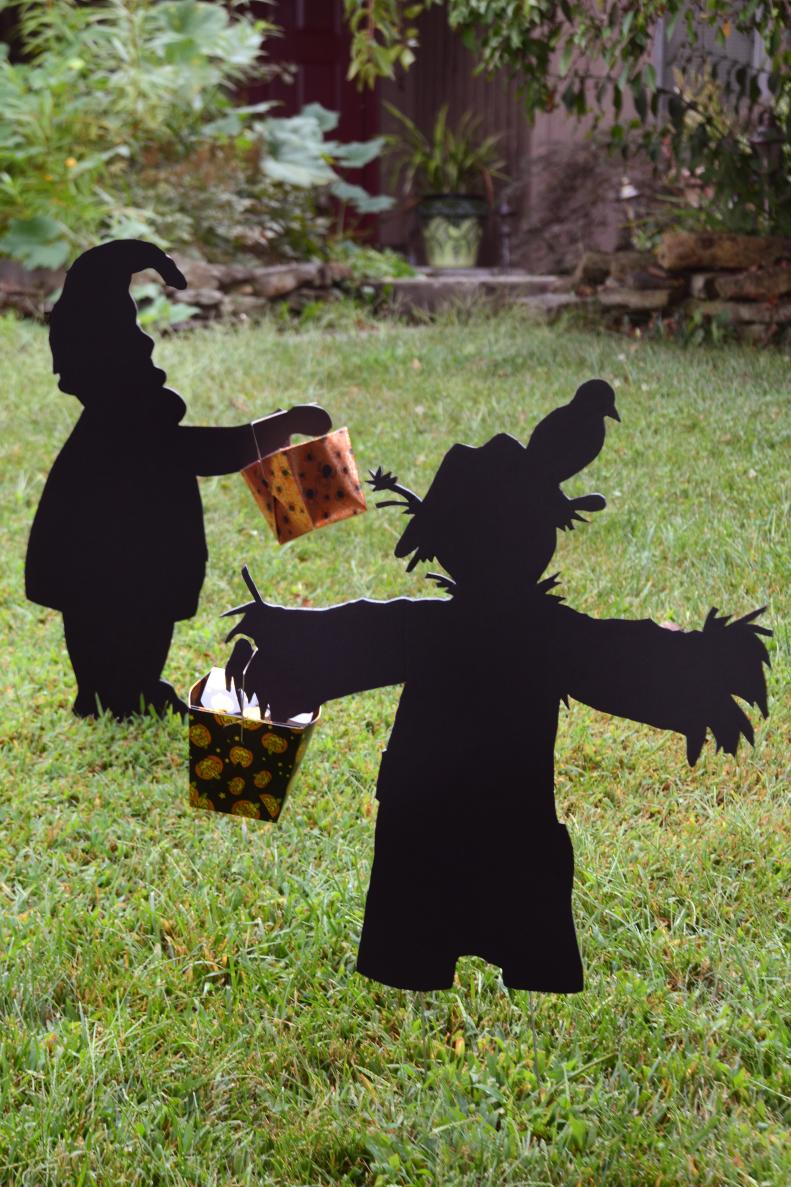 This garden gnome and his scarecrow friend are ready for an evening of welcoming trick-or-treaters to the door! You can fill their little baskets with candy or toys for the kids to pick up on their way by. If you have the right tools, cut these yard silhouettes out of plywood and paint them black for yard ornaments that will last for many years. If all you have is a boxcutter, you can cut this guys out of foam core for a fun decoration that will last for the season.