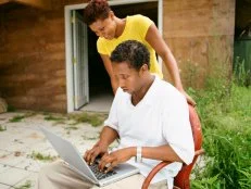 Couple with laptop by shed