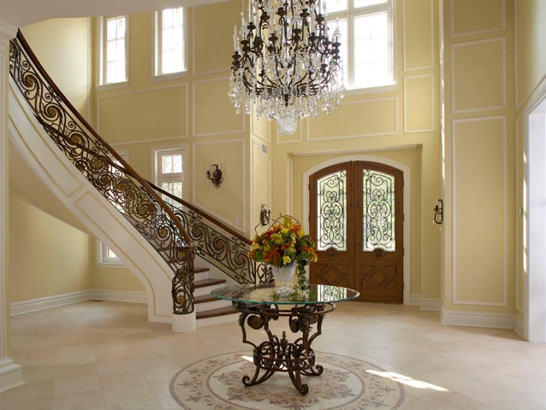 Entry With Crystal Chandelier, Iron Stair Railing and Tile Floors