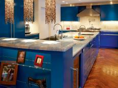 Modern Kitchen With Bright Blue Cabinets and Quartz Pendants