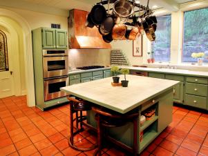 Green Cabinets Complement Terra Cotta Tile Floor