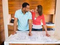 Man and Woman Looking over Blueprint