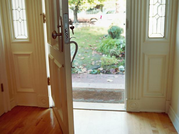 Open door of house, key in keyhole