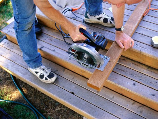 Carpenter Sawing Boards