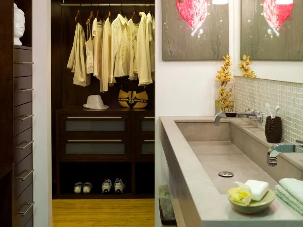 an efficient use of space was created by combining the master bathroom and master closet.to save space, no door was used between the two areas.closet system keeps the closet organized.trough sink and hanging fluorescent pendants add a modern touch. 