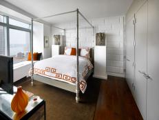 A White Bedroom with Orange Accessories.  