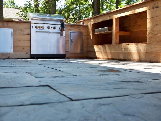 As seen on DIY Man Caves, this mahogony bar and barbecue area is inspired by an outdoor Japanese man cave. The patio floor is slate and wood cabinets are built for the bbq.