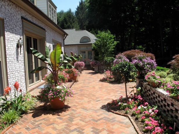 A beautiful outdoor landscaped brick paver patio.