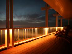 After sunset, a deck showing off railing lights as a lighting option.
