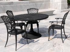 A tight shot of wrought iron patio dining table and chairs furniture.