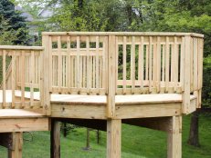 A wide shot of a light colored wood deck railing for the deck.