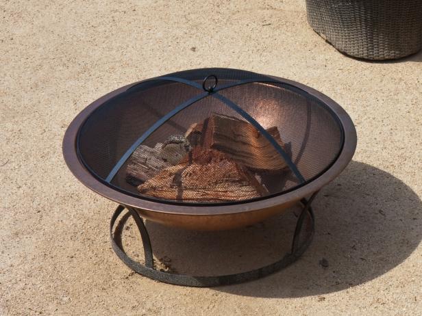 A tight shot of an elegant backyard copper firepit.