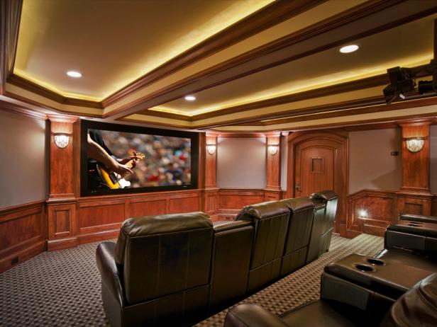 This room was transformed from a less than perfect basement storage room to a striking home theater, complete with warm wood detail, dramatic LED accent lighting, and powerful audio video capabilities. Inviting Home Theater. 
