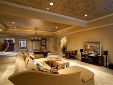 The homes Arabian influence is reflected in the hues and silhouettes of this media room, which is outfitted with audio and video gear that performs to the homeowners high standards without detracting from the rooms aesthetics.