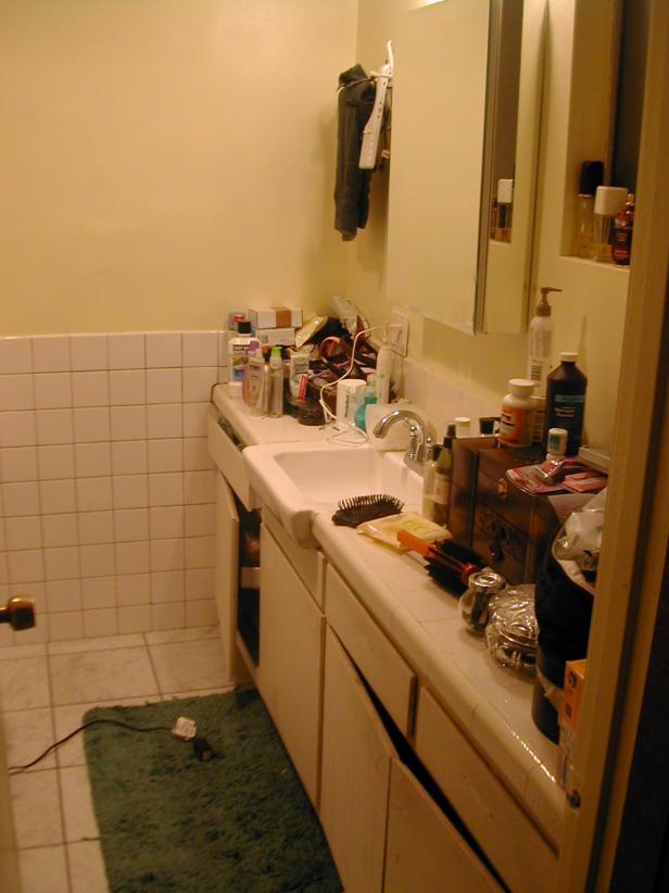 Before photo of cramped and inefficient master bathroom.