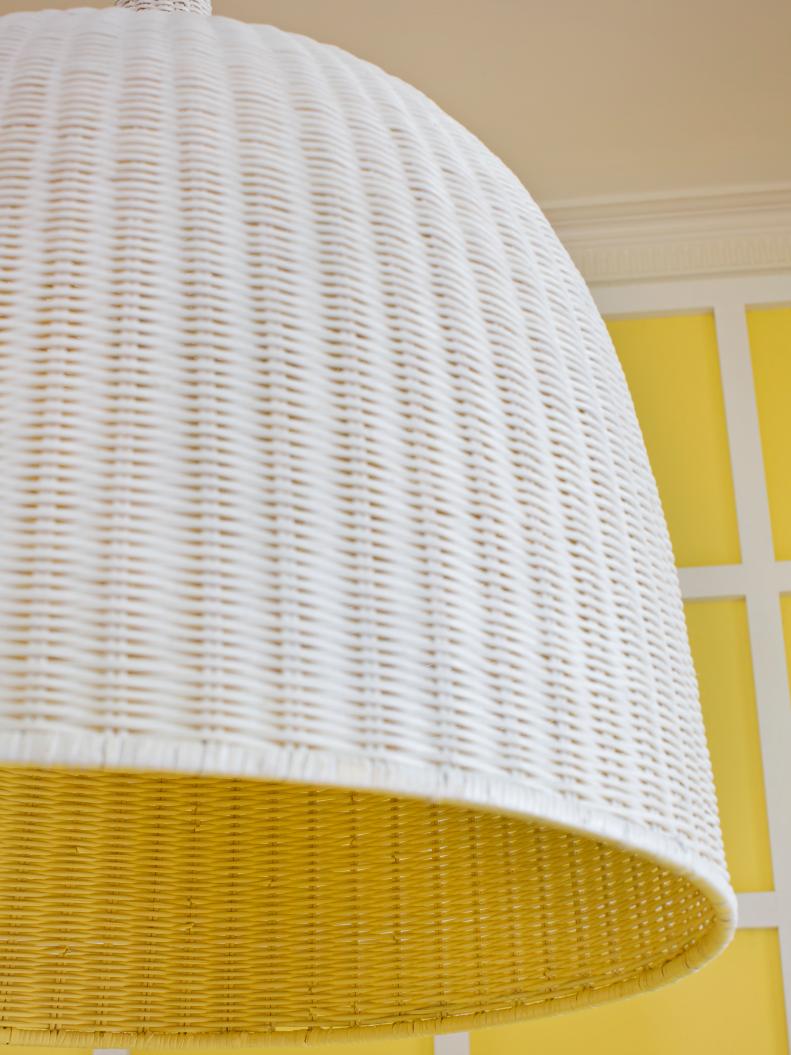 Yellow Dining Room featuring a White Wicker Hanging Pendant 