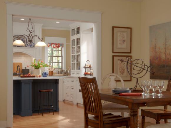 Neutral Cottage Dining Room With Wood Table and Adjacent Kitchen