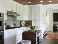 White Kitchen with Gray Subway Tile Backsplash and Dark Wood Floor 