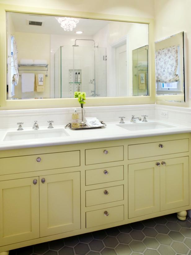 Yellow and White Cottage Bathroom With Double Vanity and Chandelier