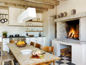 Neutral Kitchen With Rustic Beams, Stone Fireplace & Tile Floor