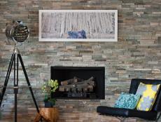Living Space With Industrial Lighting and Gray Stone Fireplace