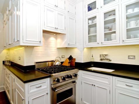 Small kitchen with exhaust fan hidden up inside cabinetry rather than large  hood dominating the space…