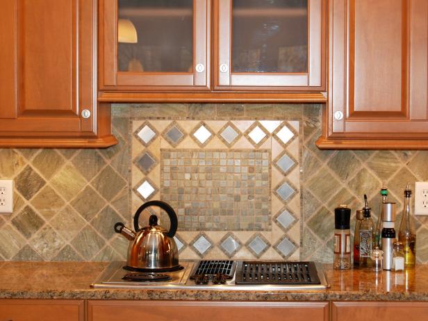 A tight shot of tumbled marble backsplash under the cabinets in the kitchen.