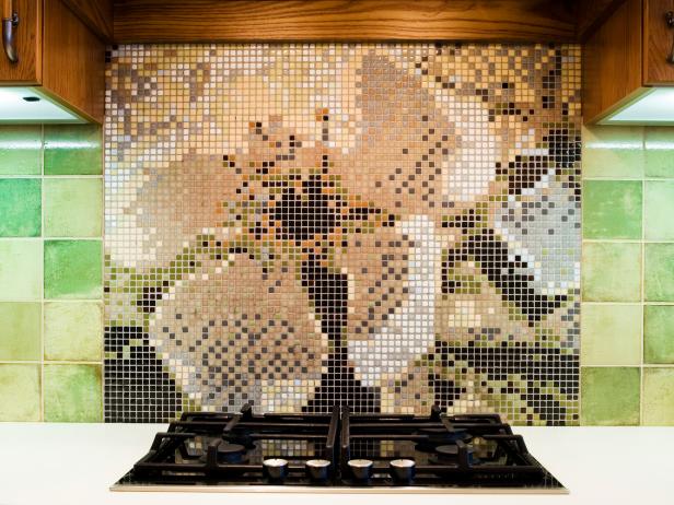 A tight shot of a mosaic tile backsplash image of a flower in the kitchen.
