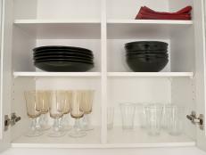 Open kitchen cabinets with dishes and glasses