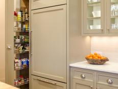 HGTV Remodels Room Stories Transitional Kitchen with butcherblock island and glass-front cabinets.