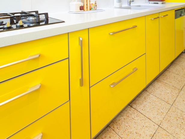 A close up of new yellow kitchen cabinets in a modern home.