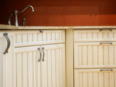 A tight shot of handles and knobs on kitchen cabinets.