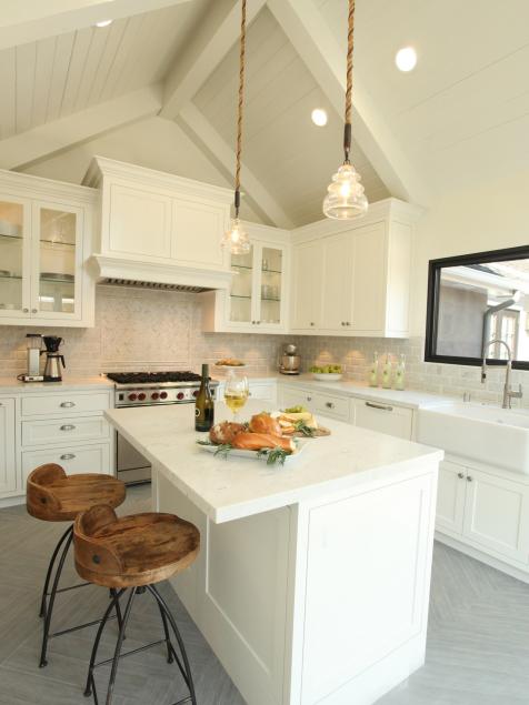 Small kitchen with exhaust fan hidden up inside cabinetry rather than large  hood dominating the space…