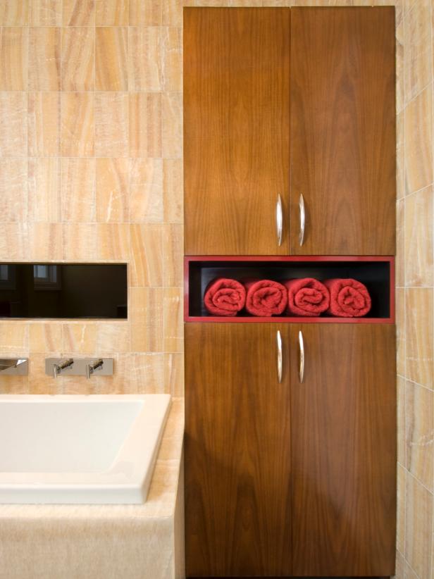 Brown Wooden Cabinetry with Red Towels.  