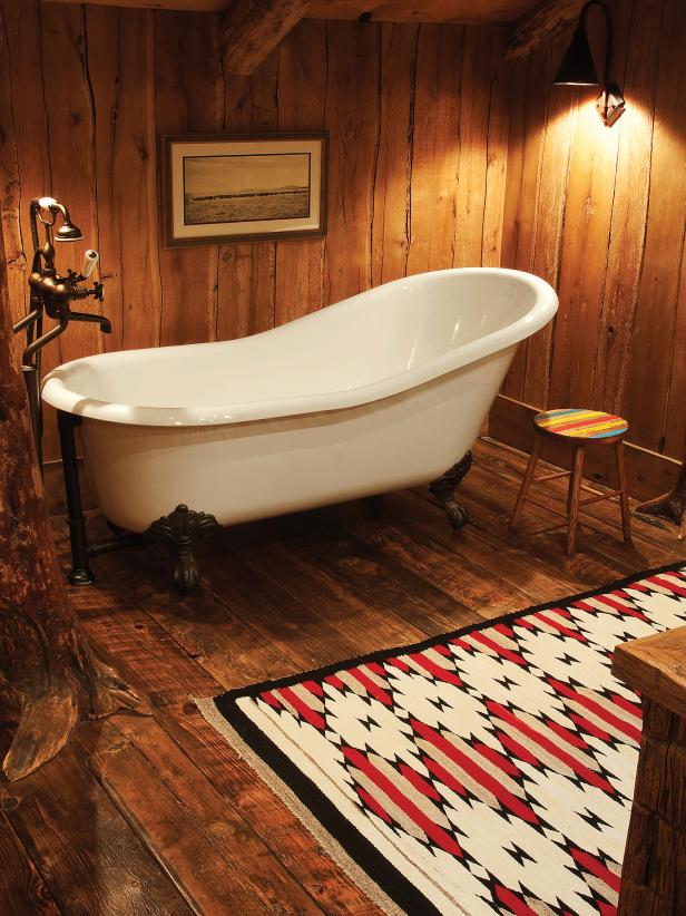 A massive bathtub complete with claw feet occupies the kids bathroom ont he second floor. Industrial faucets add to the setting and a vintage Navajo carpet completes the room. 