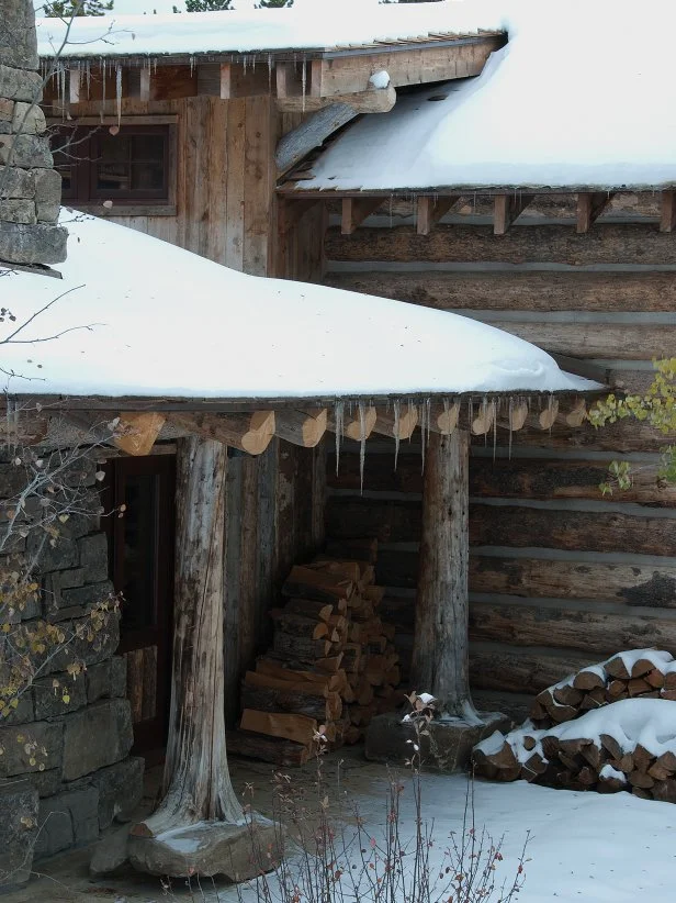 The exterior of the home is architecturally interesting with several different levels and entranceways. The seasons first snowfall reminds one that firewood needs to be stacked early.