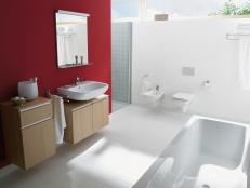 Modern White Bathroom With Red Accent Wall and Floating Vanities