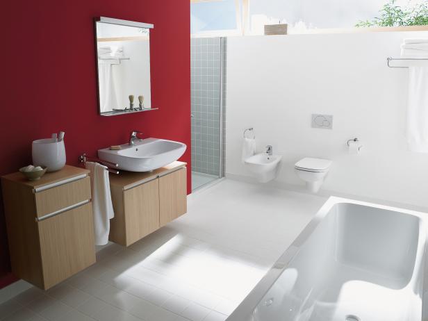 Modern White Bathroom With Red Accent Wall and Floating Vanities