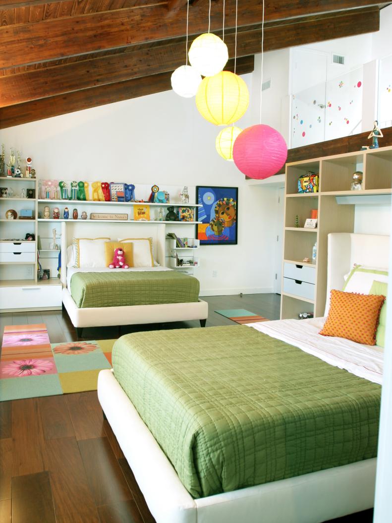 White Kids' Room With Sloped Wood Ceiling and Colorful Paper Lanterns