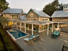 Clad in environmentally responsible lumber, the home's back deck offers both poolside and patio-style seating.